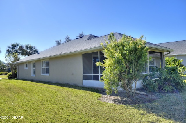 view of home's exterior featuring a yard and a sunroom