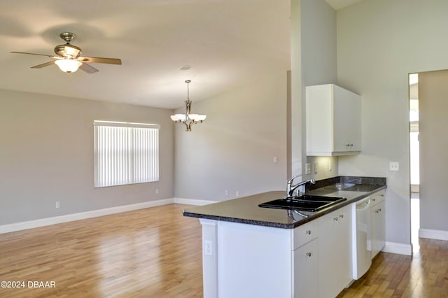 kitchen featuring white dishwasher, sink, pendant lighting, white cabinets, and light hardwood / wood-style floors