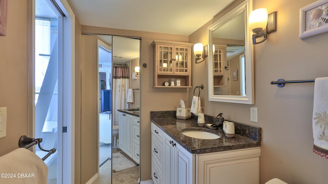 bathroom featuring toilet and vanity