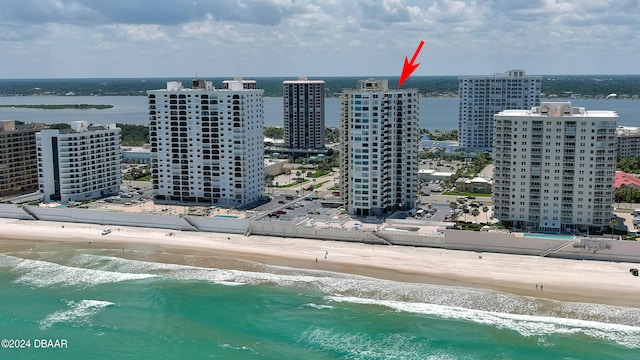 bird's eye view featuring a view of the beach and a water view