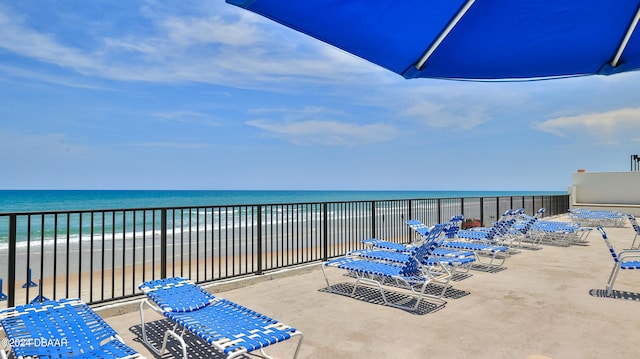 balcony with a water view and a beach view