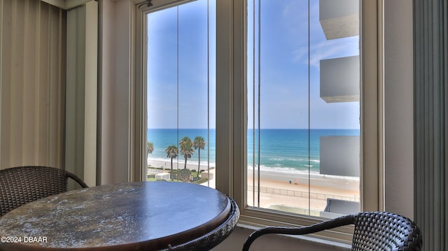 dining area featuring a beach view and a water view