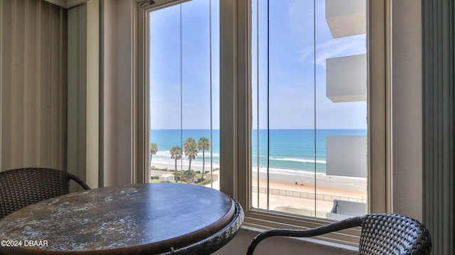 dining space with a beach view and a water view