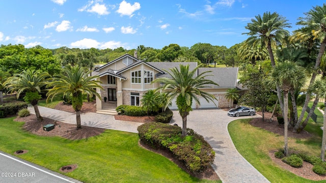 view of front of home featuring a garage and a front lawn