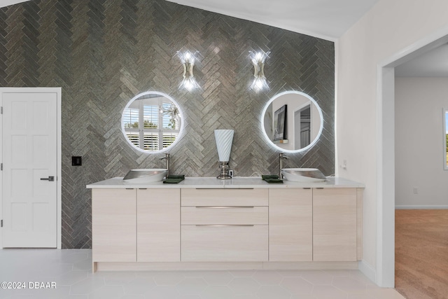 bathroom with tile walls, vanity, tile patterned floors, and vaulted ceiling