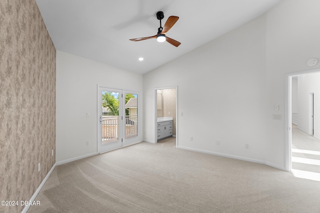 unfurnished bedroom with ensuite bathroom, access to exterior, light carpet, and ceiling fan