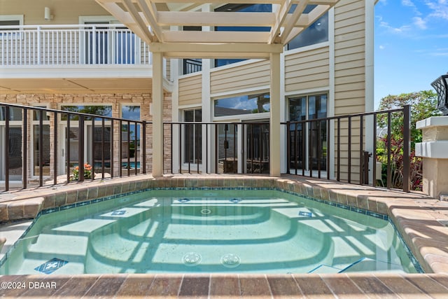 view of pool featuring an in ground hot tub