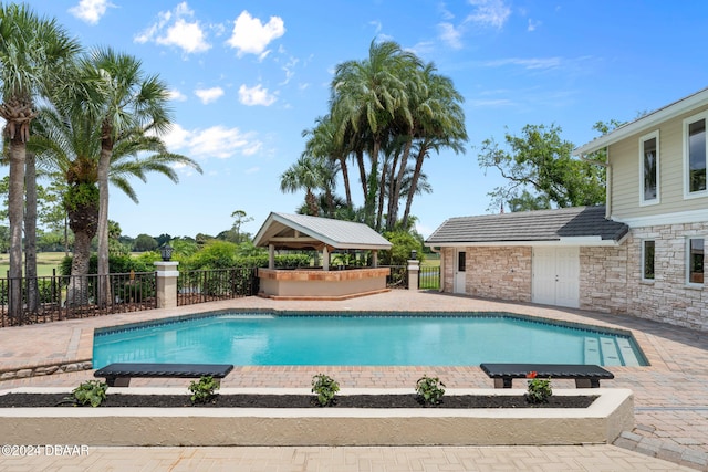 view of swimming pool with a patio and a gazebo