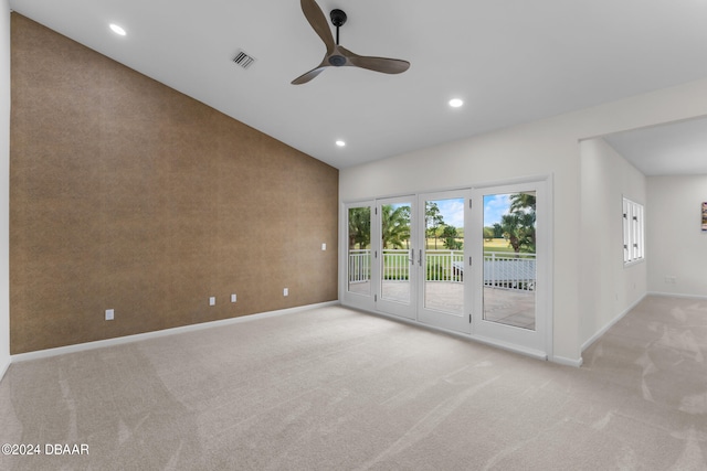 carpeted spare room with lofted ceiling and ceiling fan