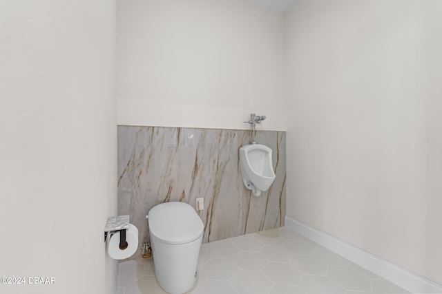 bathroom featuring toilet and tile patterned floors