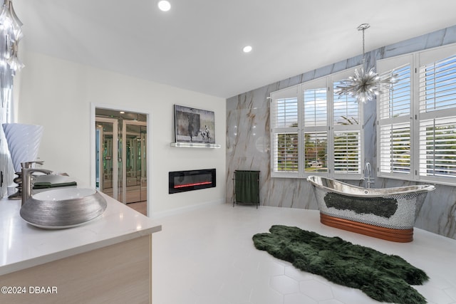 interior space featuring vanity, tile patterned floors, and a bath