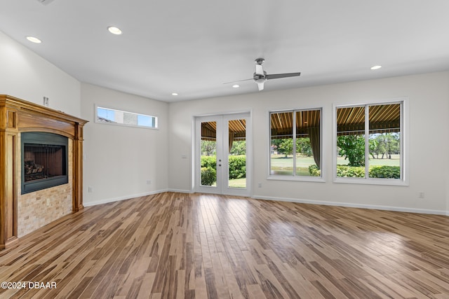 unfurnished living room with ceiling fan and light hardwood / wood-style flooring