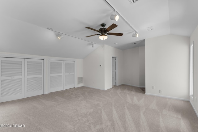 bonus room featuring ceiling fan, light colored carpet, and lofted ceiling