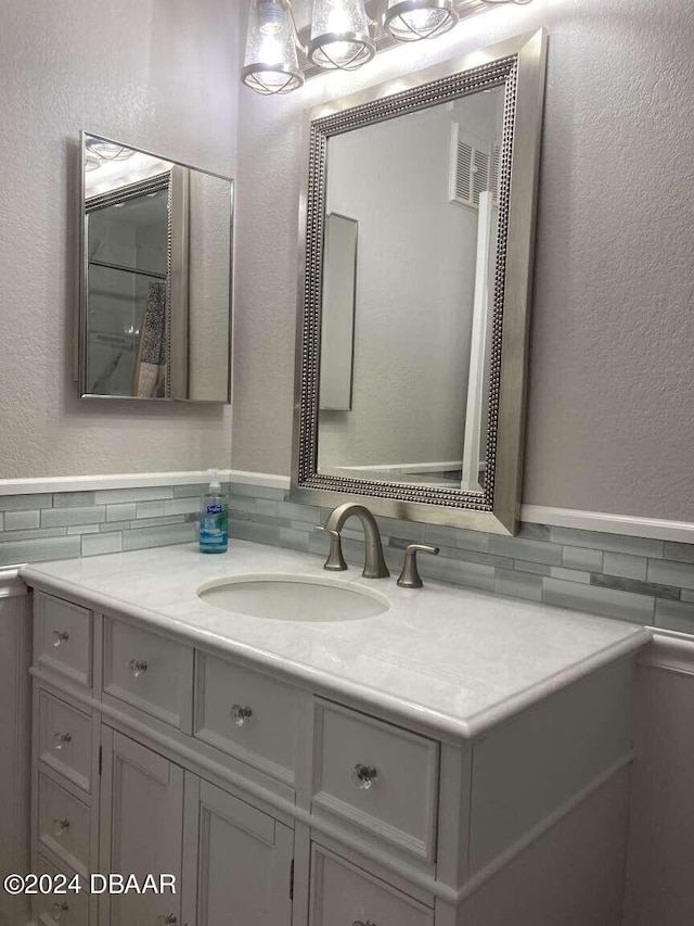 1401 S Palmetto Ave Unit 214, Daytona Beach, FL 32114 - bathroom featuring vanity and a textured wall