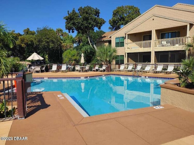 1401 S Palmetto Ave Unit 214, Daytona Beach, FL 32114 - community pool featuring a patio area and fence