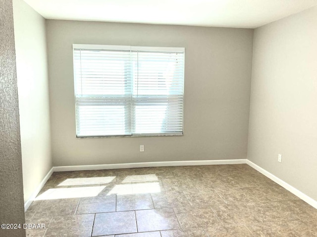 1401 S Palmetto Ave Unit 214, Daytona Beach, FL 32114 - unfurnished room with plenty of natural light and baseboards