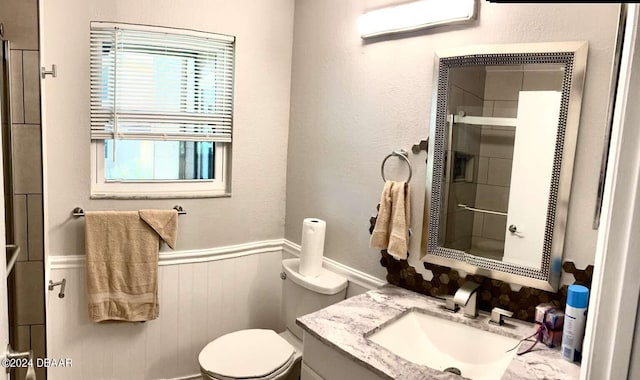 1401 S Palmetto Ave Unit 214, Daytona Beach, FL 32114 - full bath with wainscoting, a shower with door, toilet, and vanity