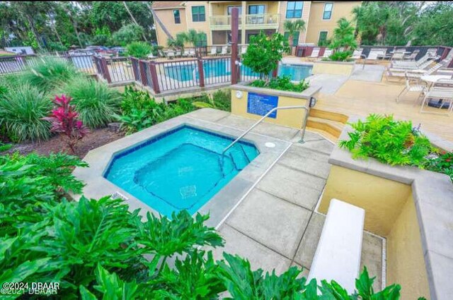 1401 S Palmetto Ave Unit 214, Daytona Beach, FL 32114 - community pool with a hot tub, a patio, and fence