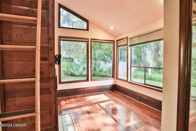 unfurnished sunroom featuring a wealth of natural light and lofted ceiling