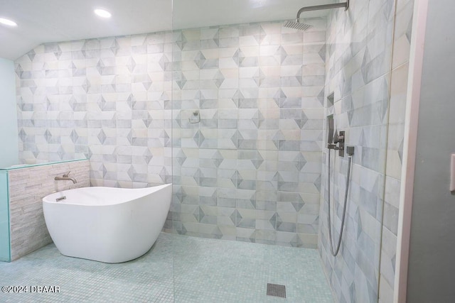 121 Willow Bend Ln, Ormond Beach, FL 32174 - bathroom featuring a tile shower, a soaking tub, recessed lighting, tile patterned floors, and tile walls