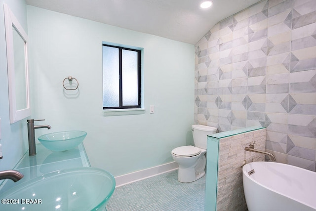 bathroom with tile walls, sink, and tile patterned flooring