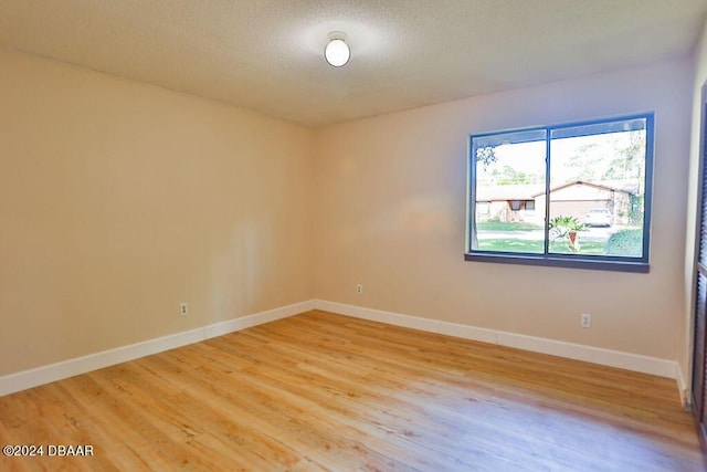 121 Willow Bend Ln, Ormond Beach, FL 32174 - unfurnished room with light wood finished floors, baseboards, and a textured ceiling