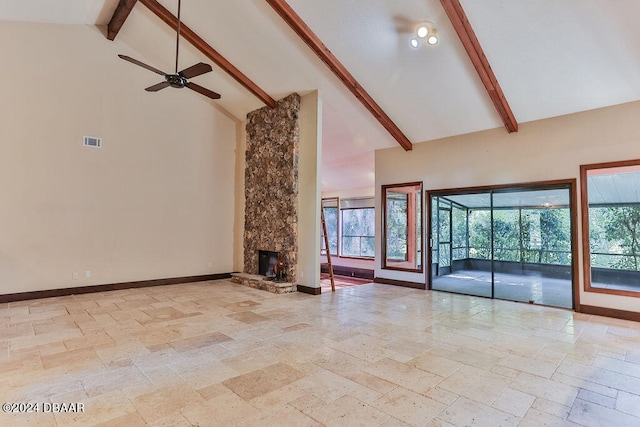 unfurnished living room with a fireplace, ceiling fan, beam ceiling, and high vaulted ceiling