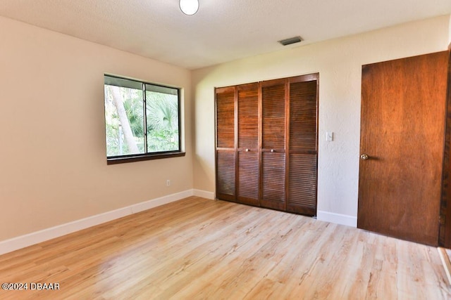 121 Willow Bend Ln, Ormond Beach, FL 32174 - unfurnished bedroom with a closet, baseboards, and wood finished floors