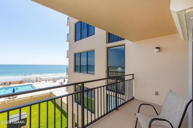 balcony with a beach view and a water view