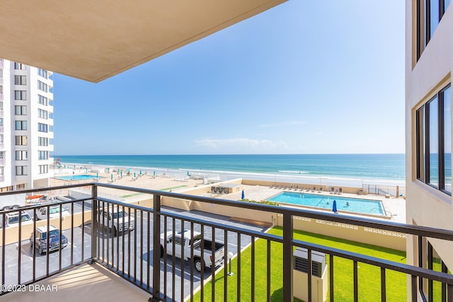 balcony featuring a beach view and a water view