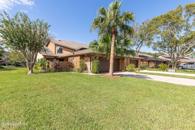 ranch-style house featuring a garage and a front yard