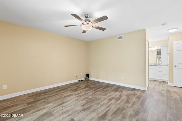 unfurnished room with ceiling fan and light hardwood / wood-style floors