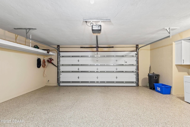 garage featuring a garage door opener and washer / clothes dryer