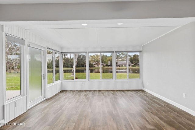 unfurnished sunroom with a water view and a wealth of natural light