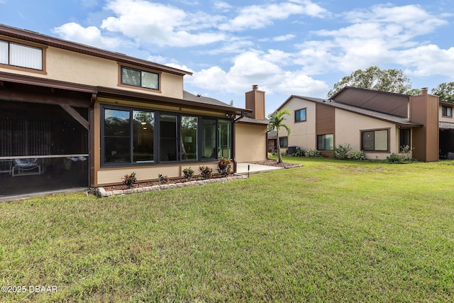 rear view of property featuring a yard