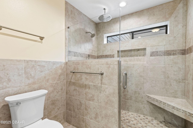 bathroom with tile walls, an enclosed shower, and toilet