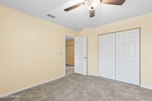 unfurnished bedroom with light carpet, ceiling fan, and a closet