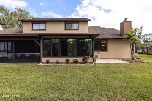 rear view of property with a yard, a patio area, and ac unit