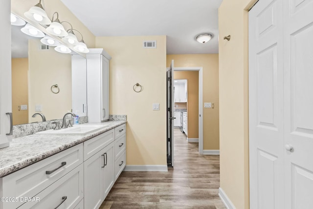 bathroom featuring hardwood / wood-style flooring and vanity