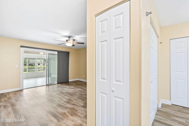 unfurnished room featuring ceiling fan and light wood-type flooring