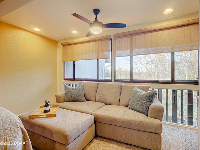 living room featuring carpet and ceiling fan