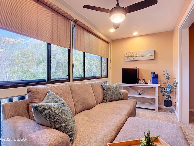 carpeted living room with ceiling fan