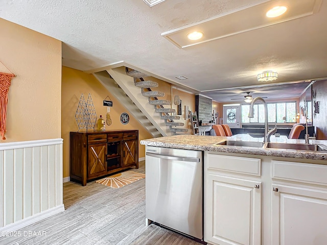 kitchen featuring white cabinets, ceiling fan, sink, light hardwood / wood-style flooring, and dishwasher