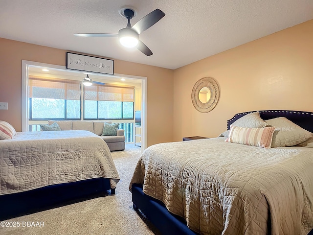 carpeted bedroom with a textured ceiling and ceiling fan