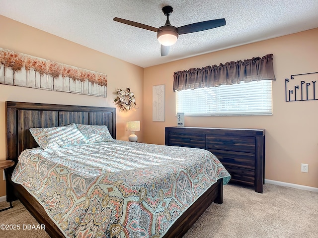 carpeted bedroom featuring ceiling fan and a textured ceiling