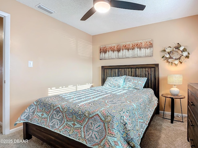 carpeted bedroom with a textured ceiling and ceiling fan