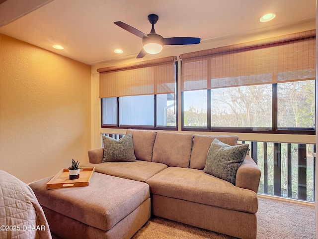 carpeted living room featuring ceiling fan