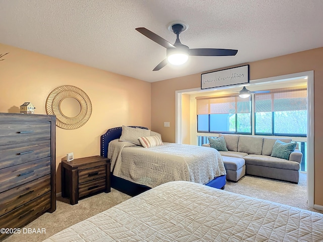 bedroom with light carpet, a textured ceiling, and ceiling fan