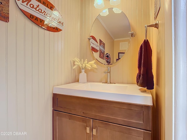 mudroom featuring wood walls, ornamental molding, and sink