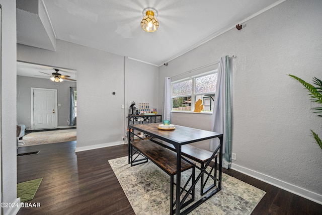 dining room featuring a textured wall, wood finished floors, and baseboards